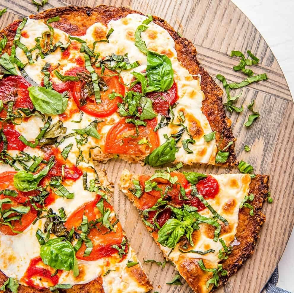 https://www.evoluerfitness.com/wp-content/uploads/2023/12/Cauliflower-Pizza-Crust-IG1-e1703284811860.jpeg